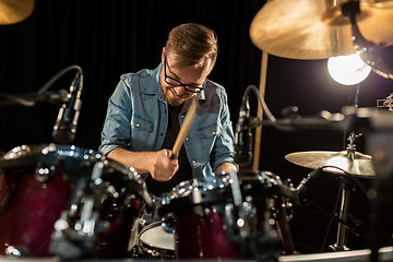 Image showing male musician playing drums and cymbals at concert