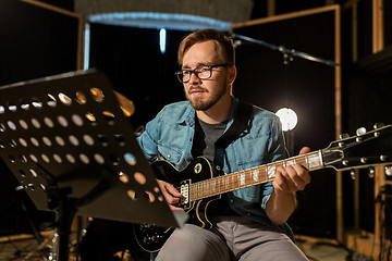 Image showing man playing guitar at studio rehearsal