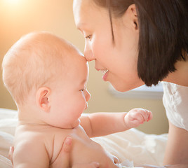 Image showing Mixed Race Chinese and Caucasian Baby Boy Laying In Bed with His