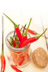 Image showing red chili peppers on a glass jar