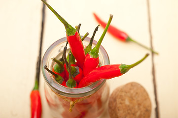 Image showing red chili peppers on a glass jar