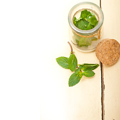 Image showing fresh mint leaves on a glass jar