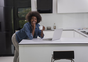Image showing smiling black woman in modern kitchen