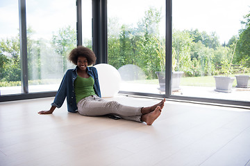 Image showing african american  woman  sitting near window