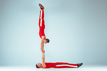 Image showing The two gymnastic acrobatic caucasian men on balance pose