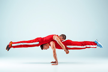 Image showing The two gymnastic acrobatic caucasian men on balance pose