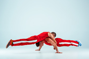 Image showing The two gymnastic acrobatic caucasian men on balance pose