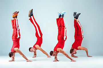 Image showing The group of gymnastic acrobatic caucasian men on balance pose