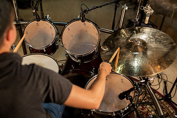 Image showing male musician playing drums and cymbals at concert