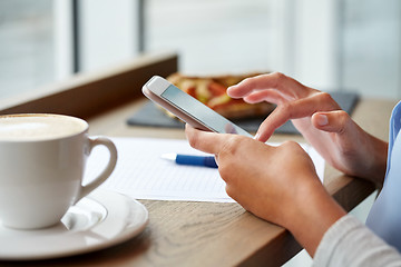 Image showing woman with smartphone at cafe