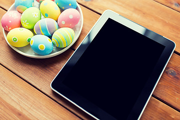 Image showing close up of easter eggs and blank tablet pc