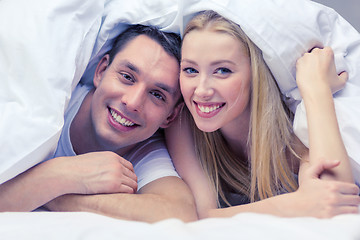 Image showing happy couple sleeping in bed