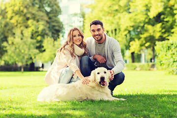 Image showing happy couple with labrador dog walking in city