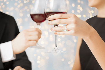 Image showing close up of engaged couple with wine glasses