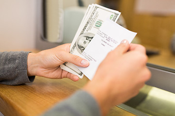 Image showing customer with money and receipt at bank counter