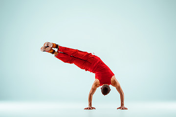 Image showing The gymnastic acrobatic caucasian man on balance pose