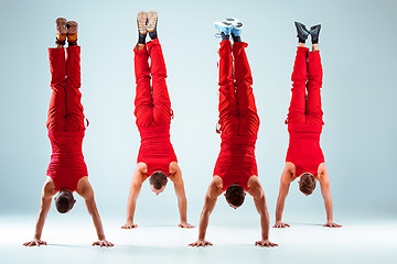 Image showing The group of gymnastic acrobatic caucasian men on balance pose