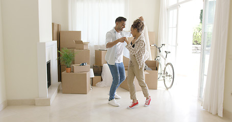 Image showing Happy young couple celebrating moving home