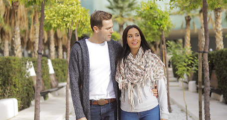 Image showing Trendy young couple walking along a promenade