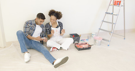 Image showing Black couple relaxes after long day of painting