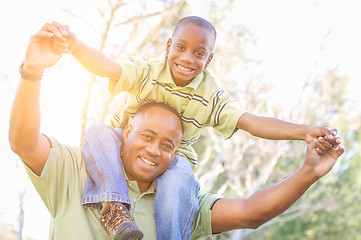 Image showing Happy African American Father and Son Riding Piggyback Outdoors