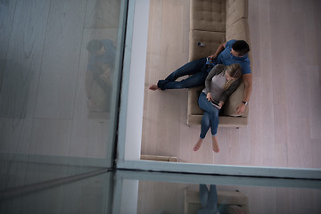 Image showing youg couple in living room with tablet top view