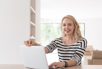 Image showing Young woman with laptop at home