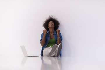 Image showing african american woman sitting on floor with laptop