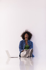 Image showing african american woman sitting on floor with laptop