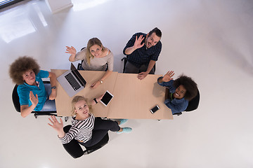 Image showing Multiethnic startup business team on meeting  top view