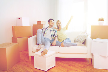 Image showing couple with boxes moving to new home and dreaming