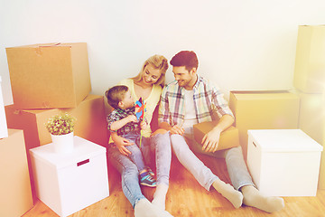 Image showing happy family with boxes moving to new home