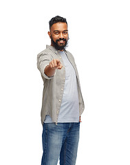 Image showing happy smiling indian man pointing finger to you