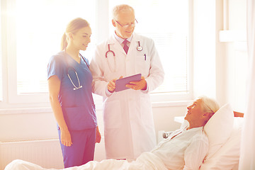 Image showing doctor and nurse visiting senior woman at hospital