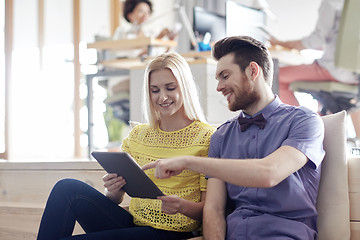 Image showing happy creative team with tablet pc in office