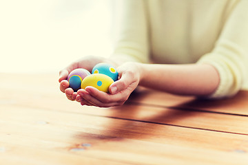 Image showing close up of woman hands with colored easter eggs