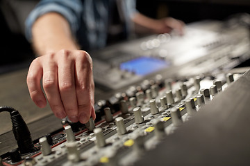 Image showing man using mixing console in music recording studio