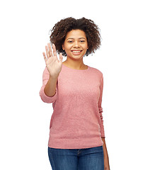 Image showing happy african woman waving hand over white