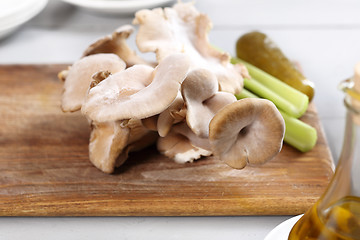 Image showing Oyster mushrooms mushrooms and olive oil. oyster mushrooms in the kitchen.