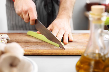 Image showing Cutting vegetables.