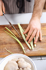 Image showing Cutting vegetables. Slicing knife vegetables.