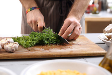 Image showing Cook the sliced fennel. Cautious chopping vegetables.