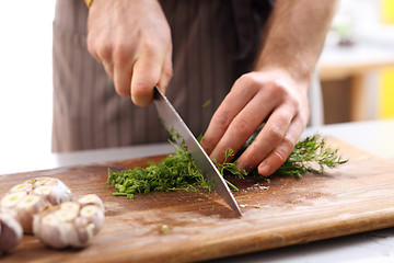 Image showing Cook the sliced fennel. Cautious chopping vegetables.