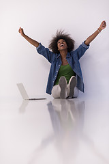 Image showing african american woman sitting on floor with laptop