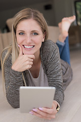 Image showing young women used tablet computer on the floor