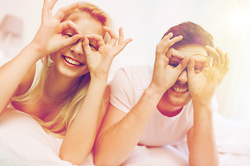 Image showing happy couple lying in bed at home