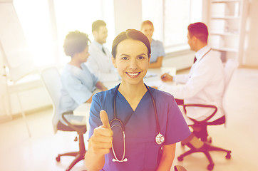 Image showing happy doctor over group of medics at hospital