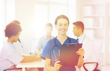 Image showing happy doctor over group of medics at hospital