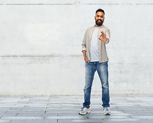 Image showing happy smiling indian man showing ok hand sign