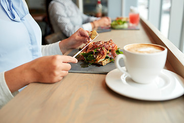 Image showing woman eating prosciutto ham salad at restaurant